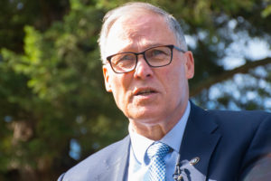 Inslee urges COVID-19 vaccinations and defends vetoes of climate change in an interview